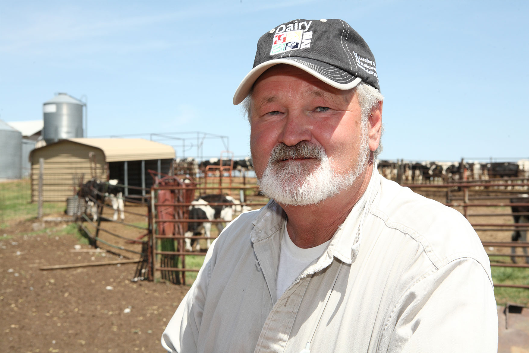 Donny Chapman poses for a photo in front of his dairy farm.