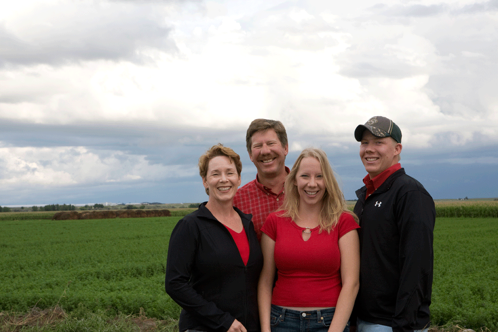 The Krafts pose in front of one of their fields.