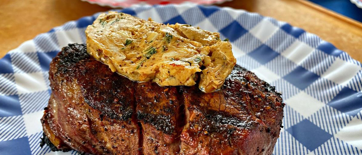 photo of a steak with butter on top